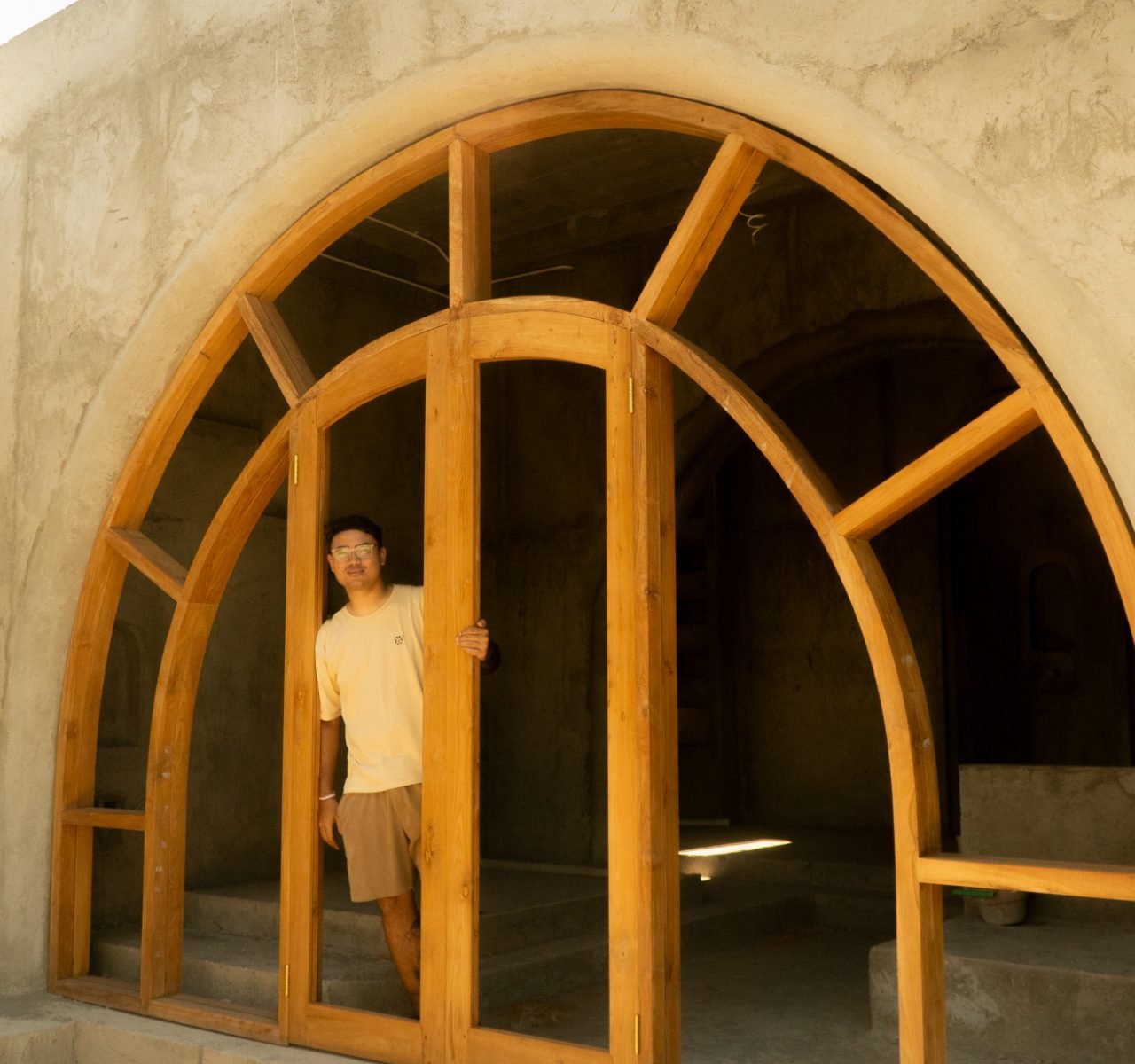 Arched timber window frame built by Arania Bali on site
